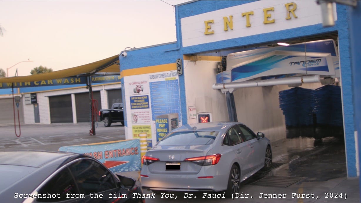 Screenshot from Thank You Dr. Fauci: Director Jenner Furst drives through a Burbank carwash while listening to Anthony Fauci's memoir on audiobook.